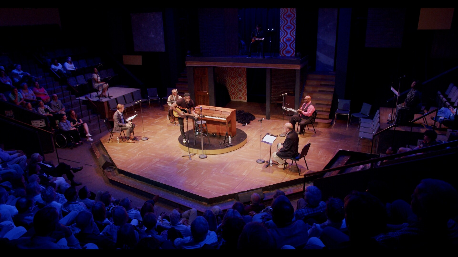 A aerial photo of a stage with a band on it.