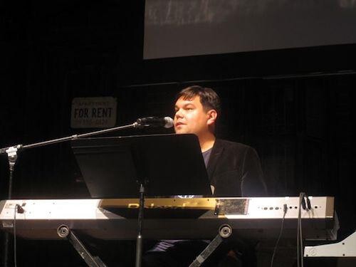 A man sitting at an electric keyboard.