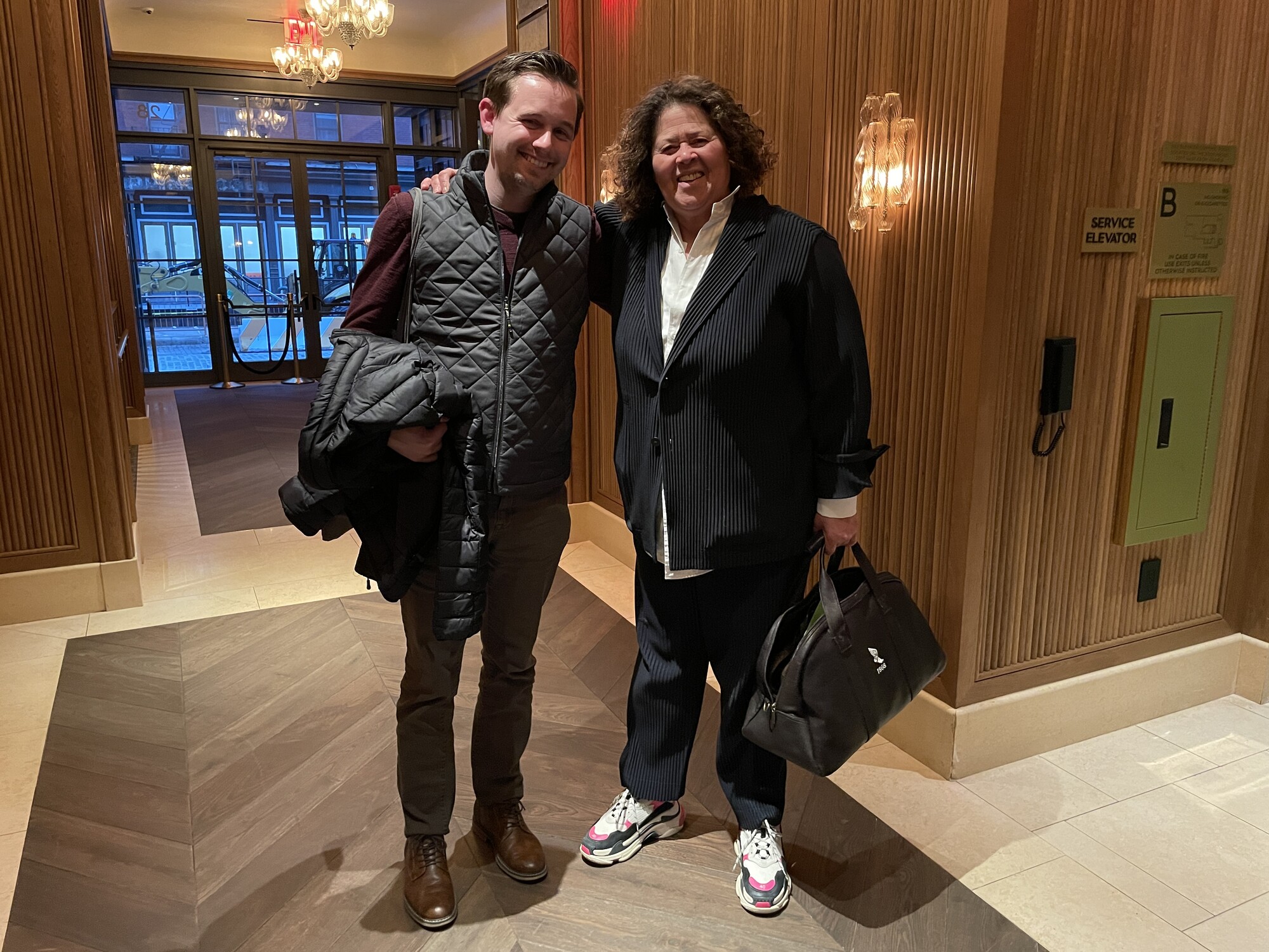 Two people embracing each other and smiling for a picture.