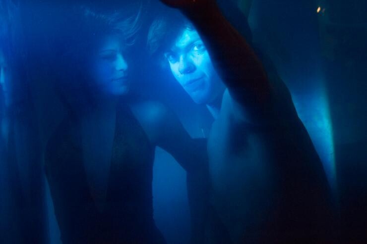 A dreamlike photo of two people underwater.