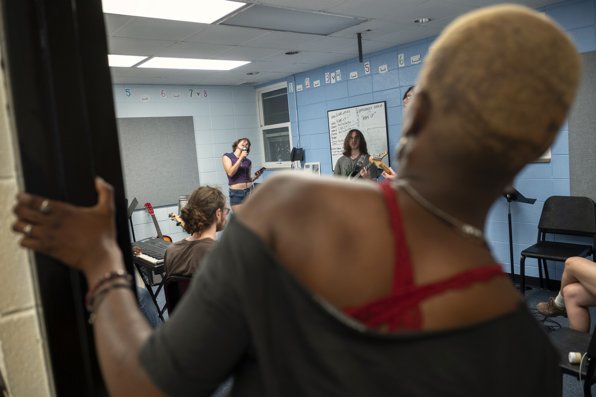 An over the shoulder shot of a person singing into a microphone.