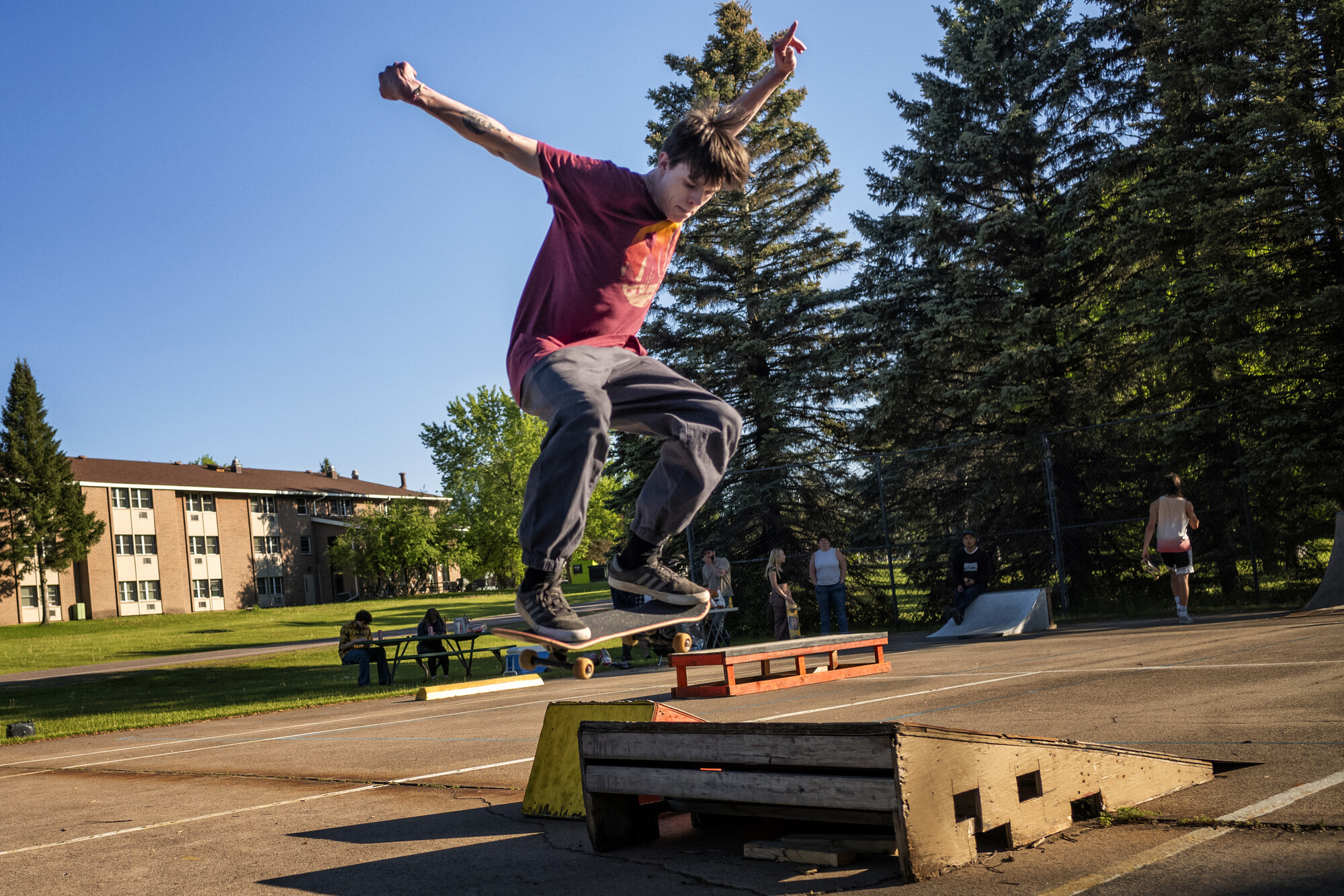 A kid airborne on a skateboard.