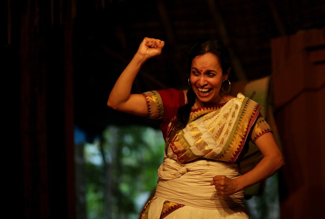 A woman raising her fist excitedly.