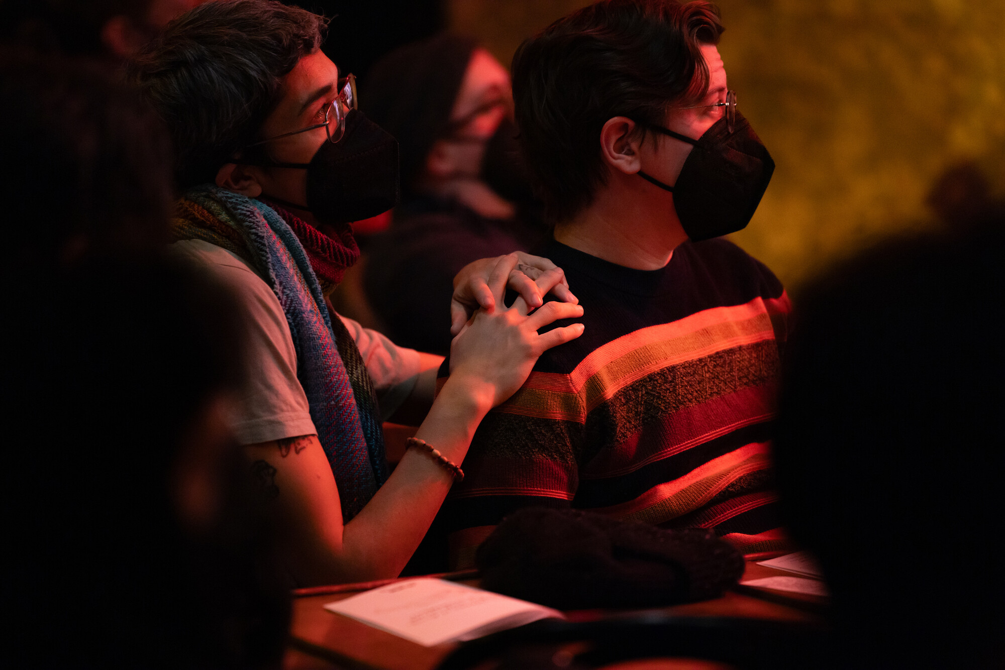A close up of two people in an audience.