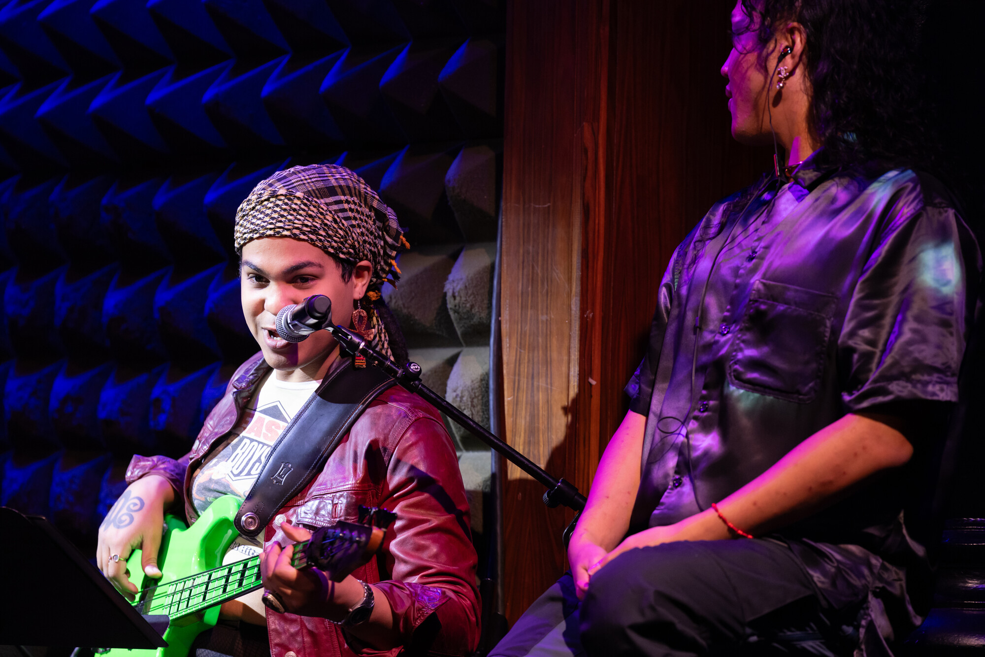 A person playing guitar on stage.