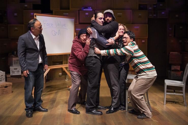 Actors in a group embrace.