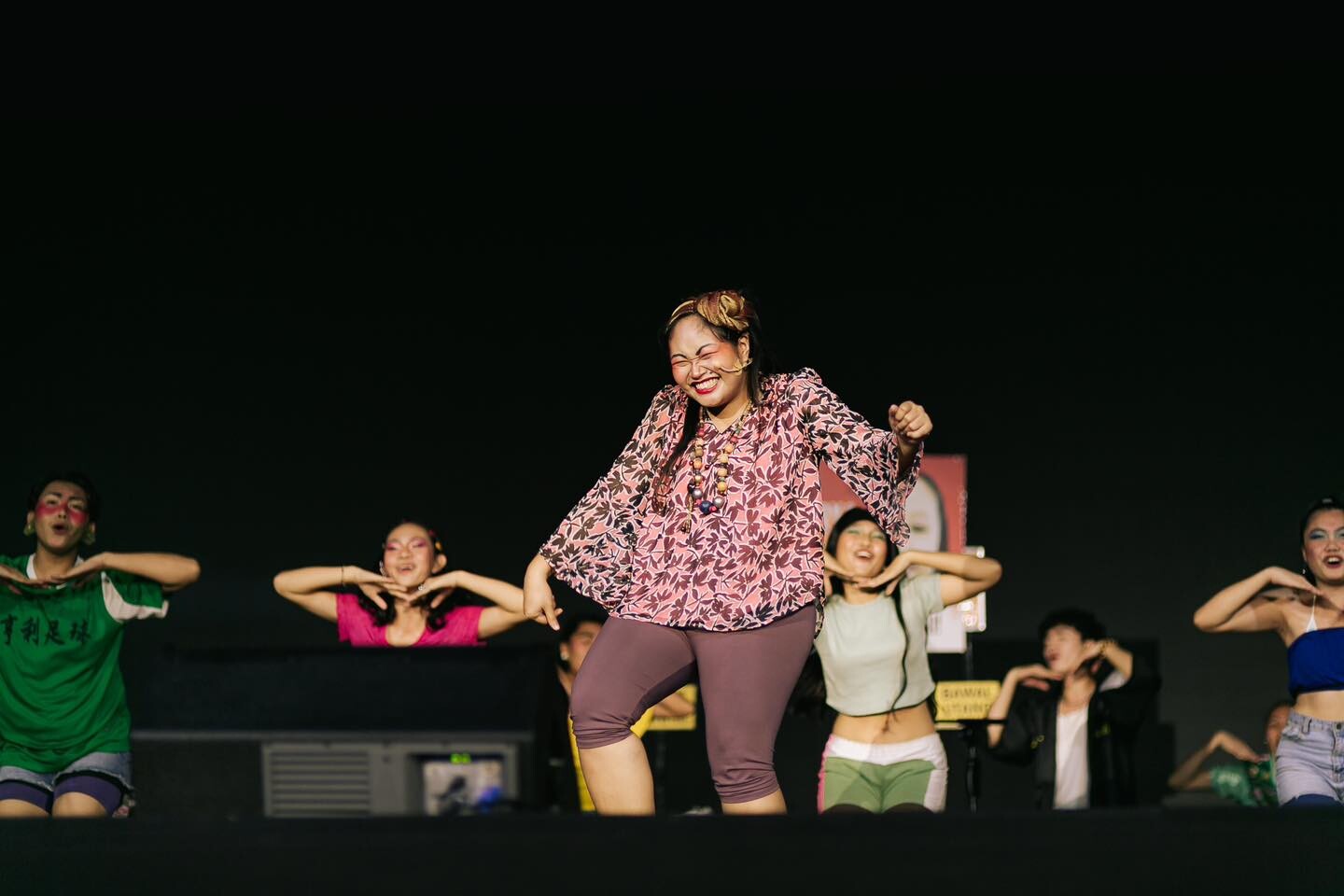 A woman curtsying on stage.