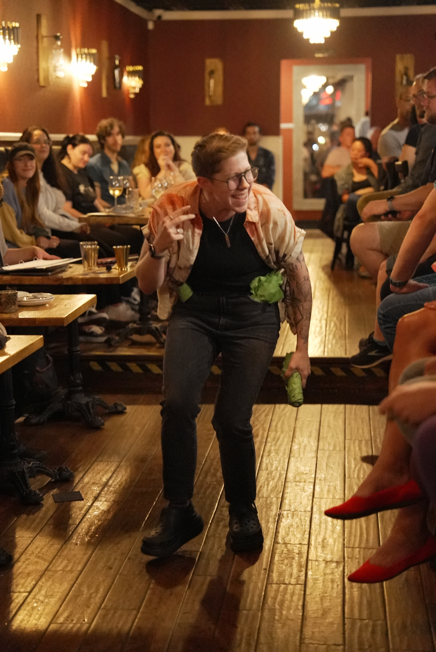 A person dancing in a restaurant dining room.