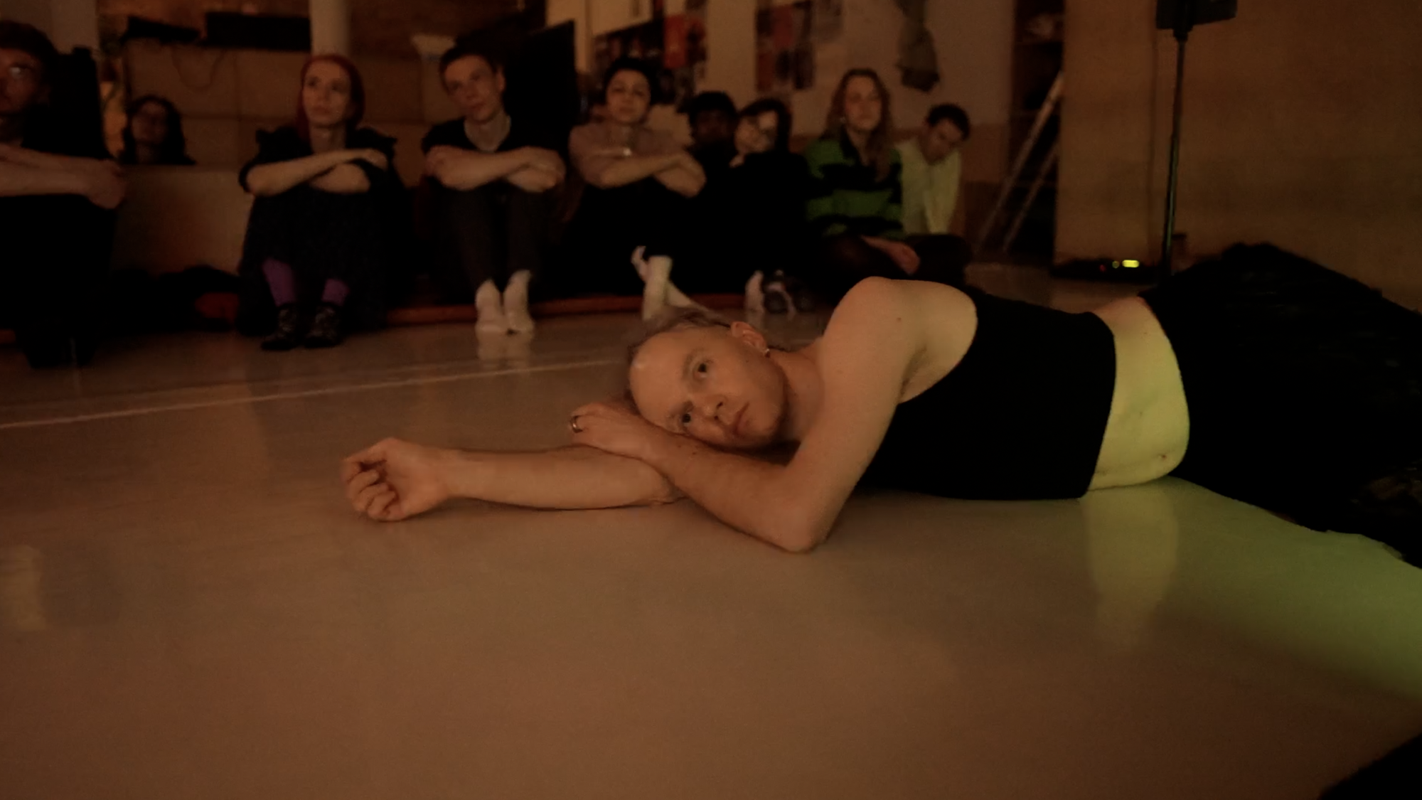 A person laying on their side on the floor.