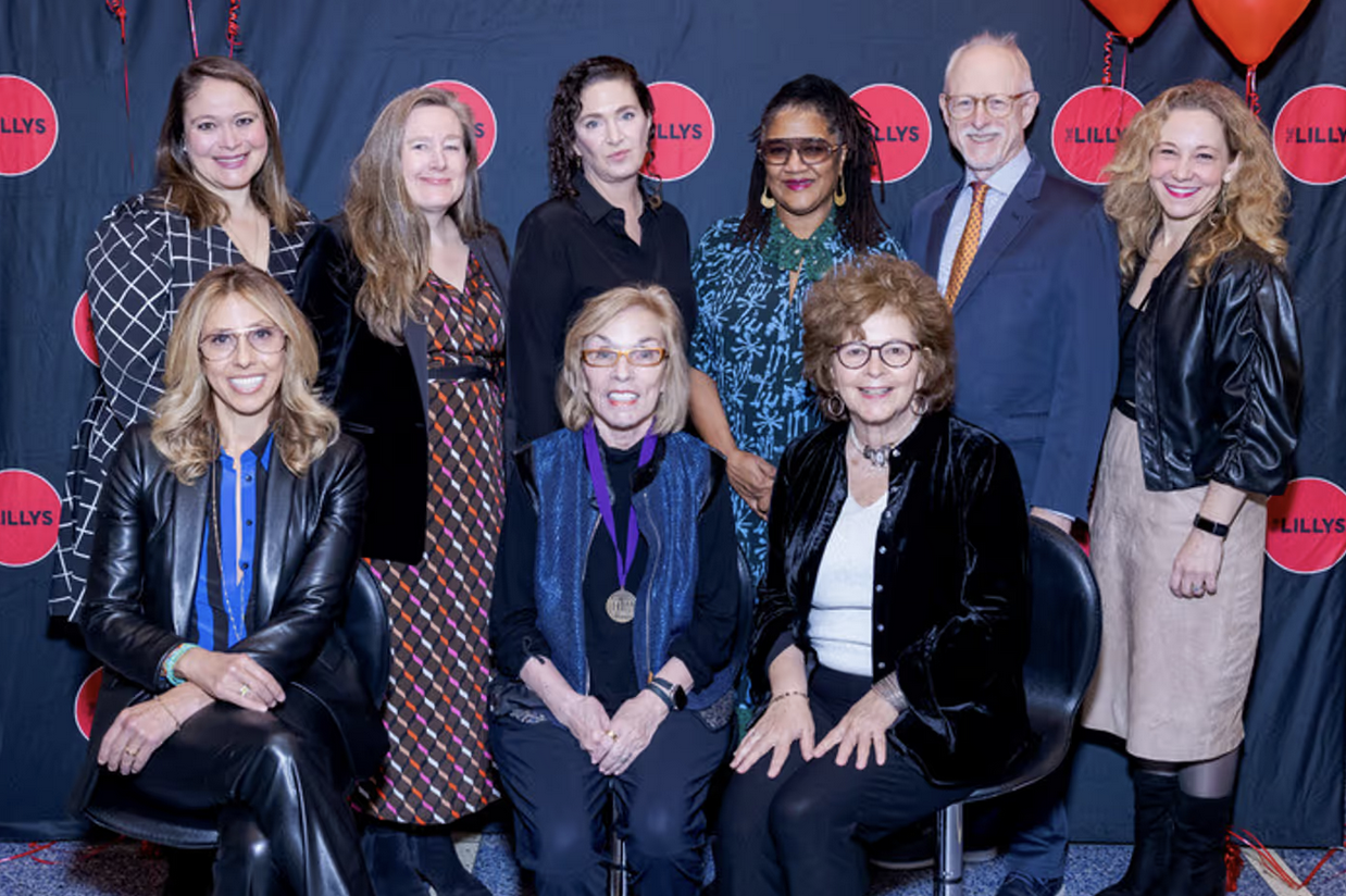 A group of older women posing for a photo together in two rows.