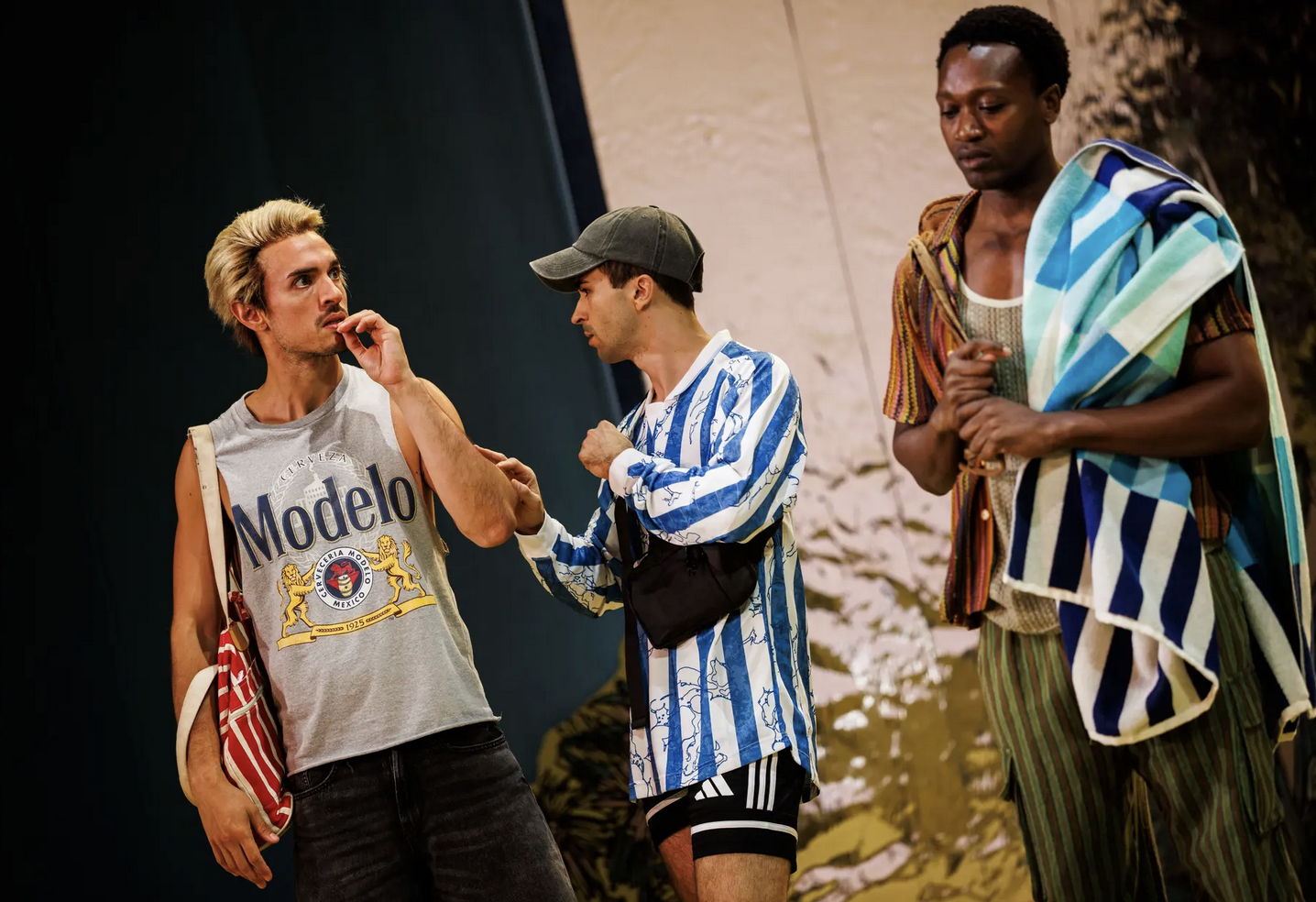 A group of actors on stage dressed like they are going to the beach.