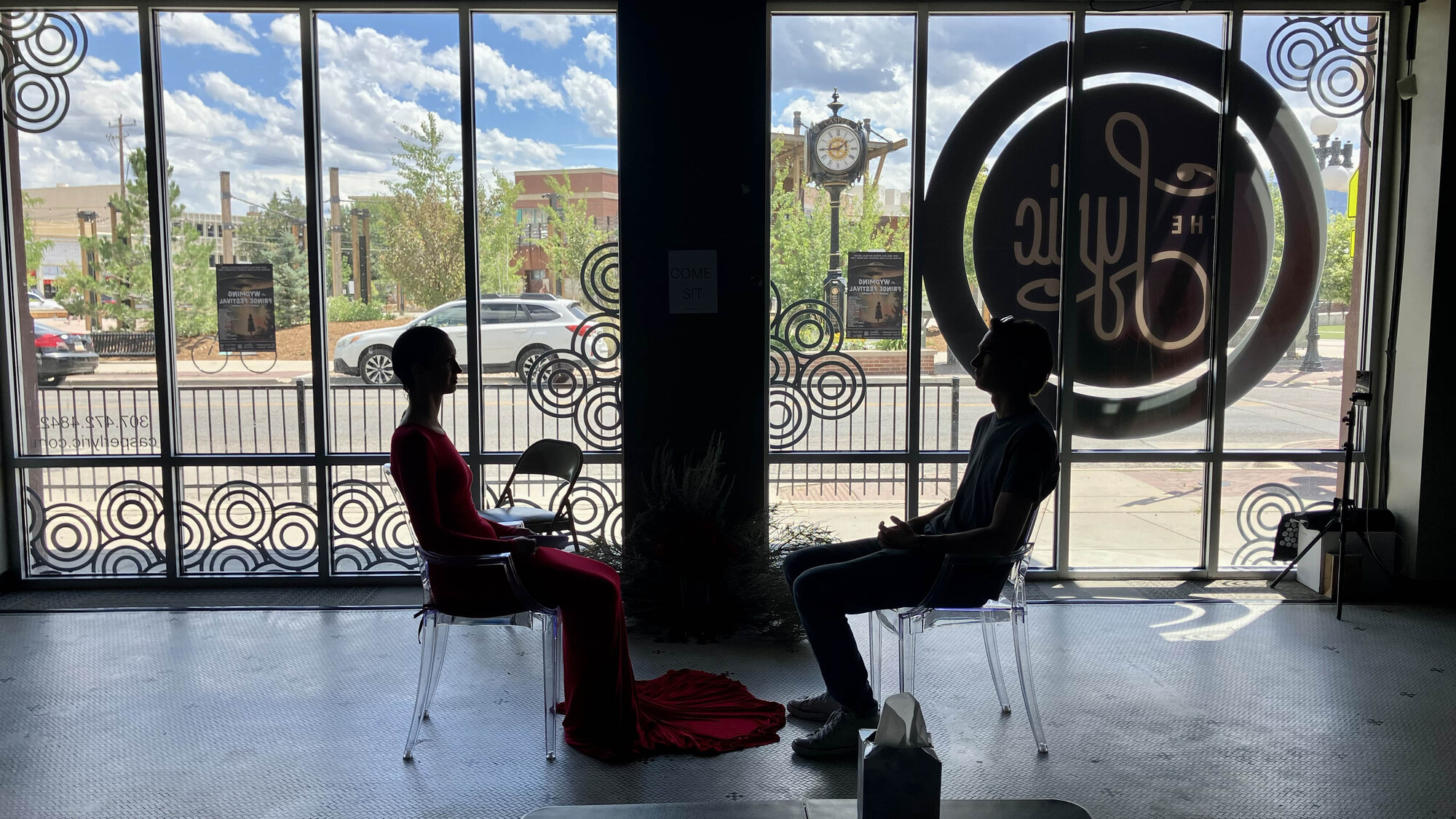 Two people sitting across from each other in a well lit room.