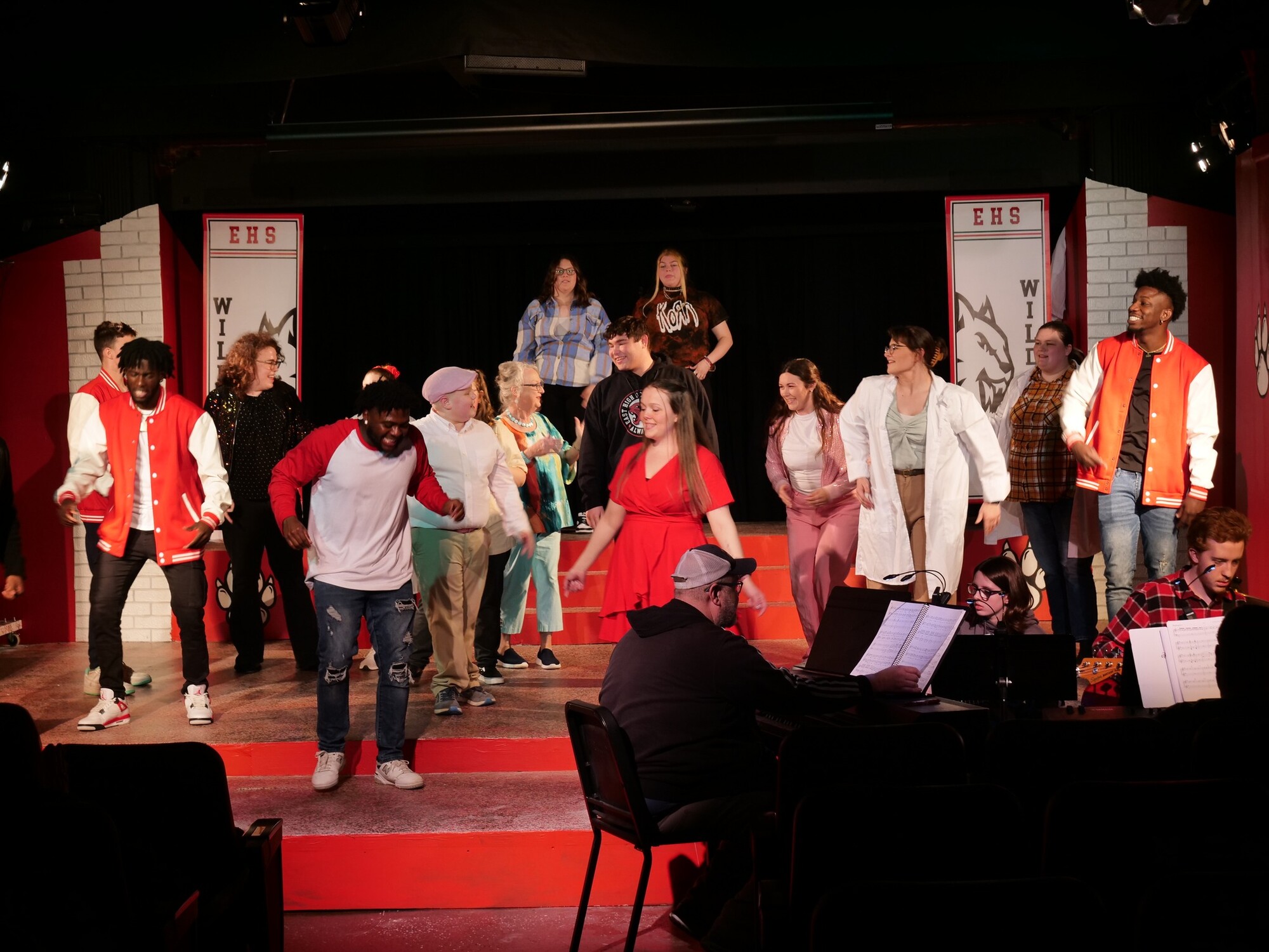 Lots of people dancing on a stage.