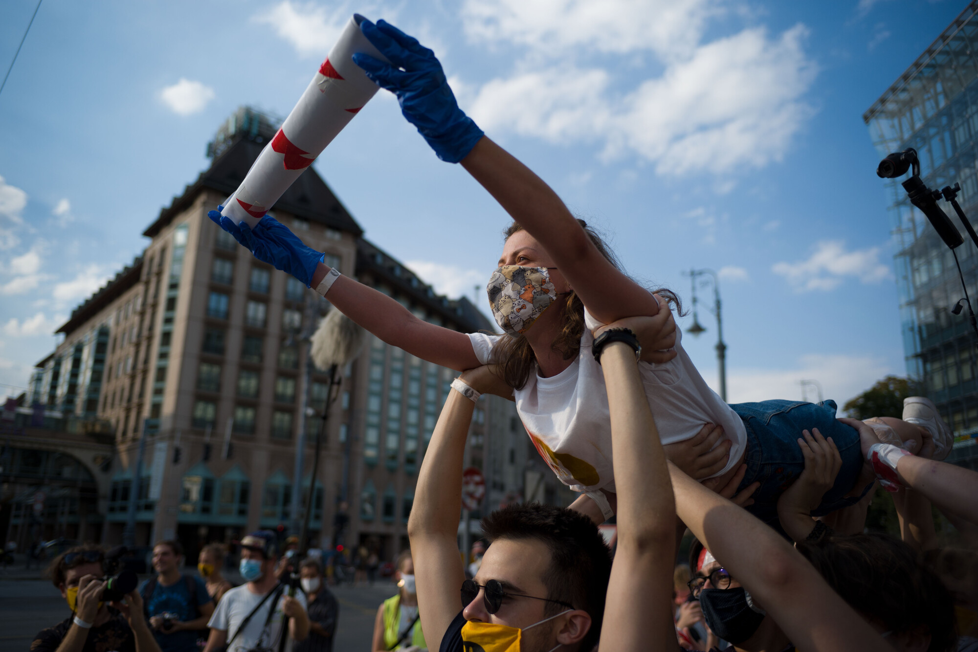 A person being held above a crowd during a protest.