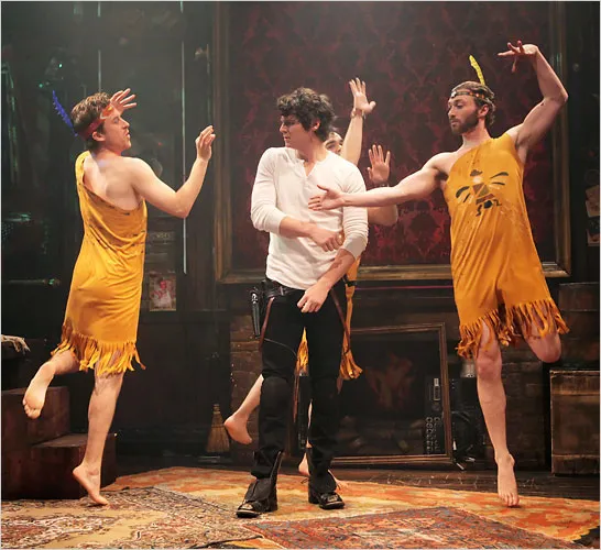 Three people in yellow tunics dancing around a man.
