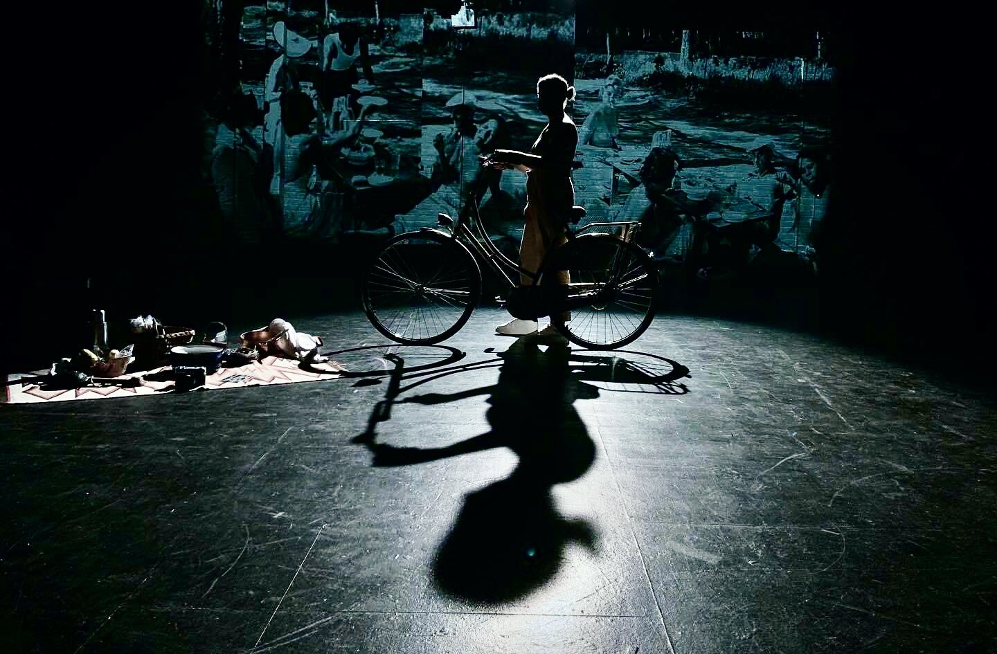 A silhouette of a person on a bicycle.