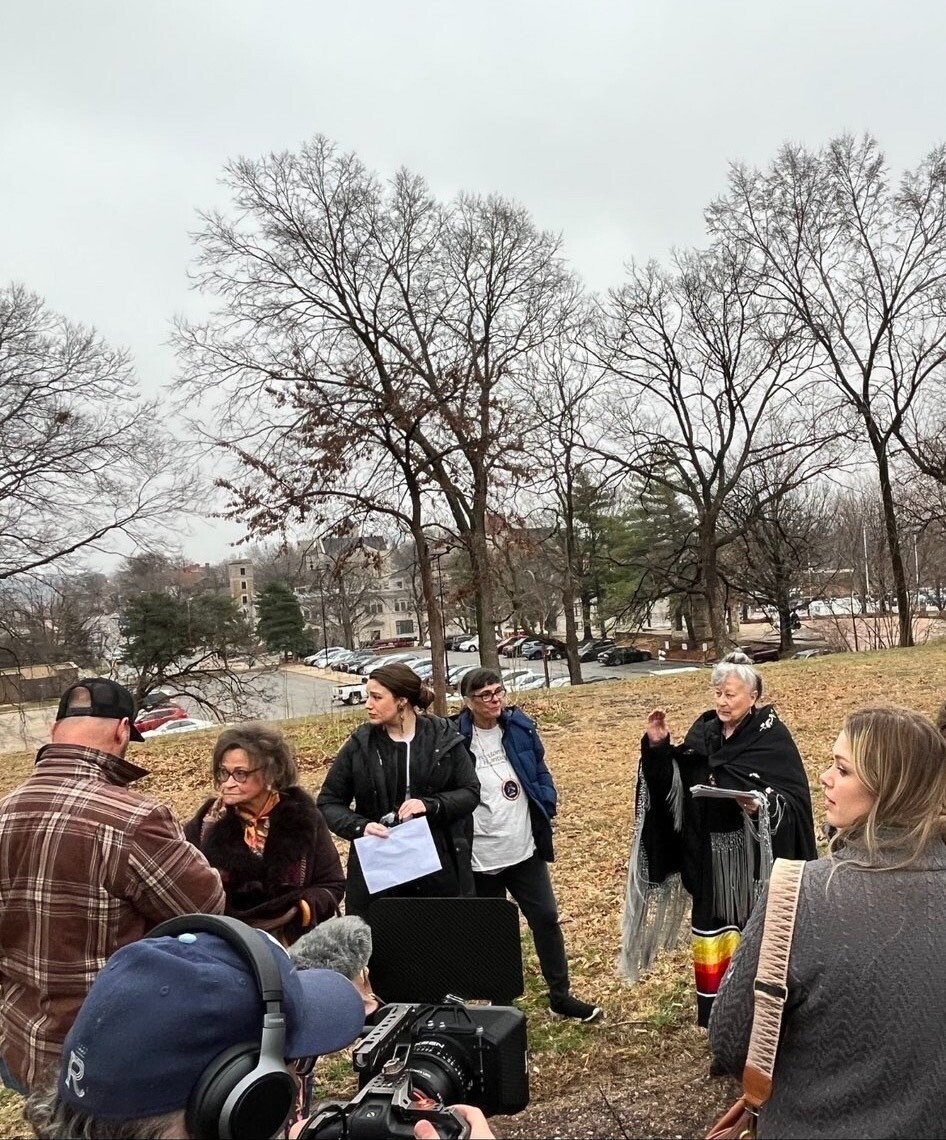 A group of people outside on a field.