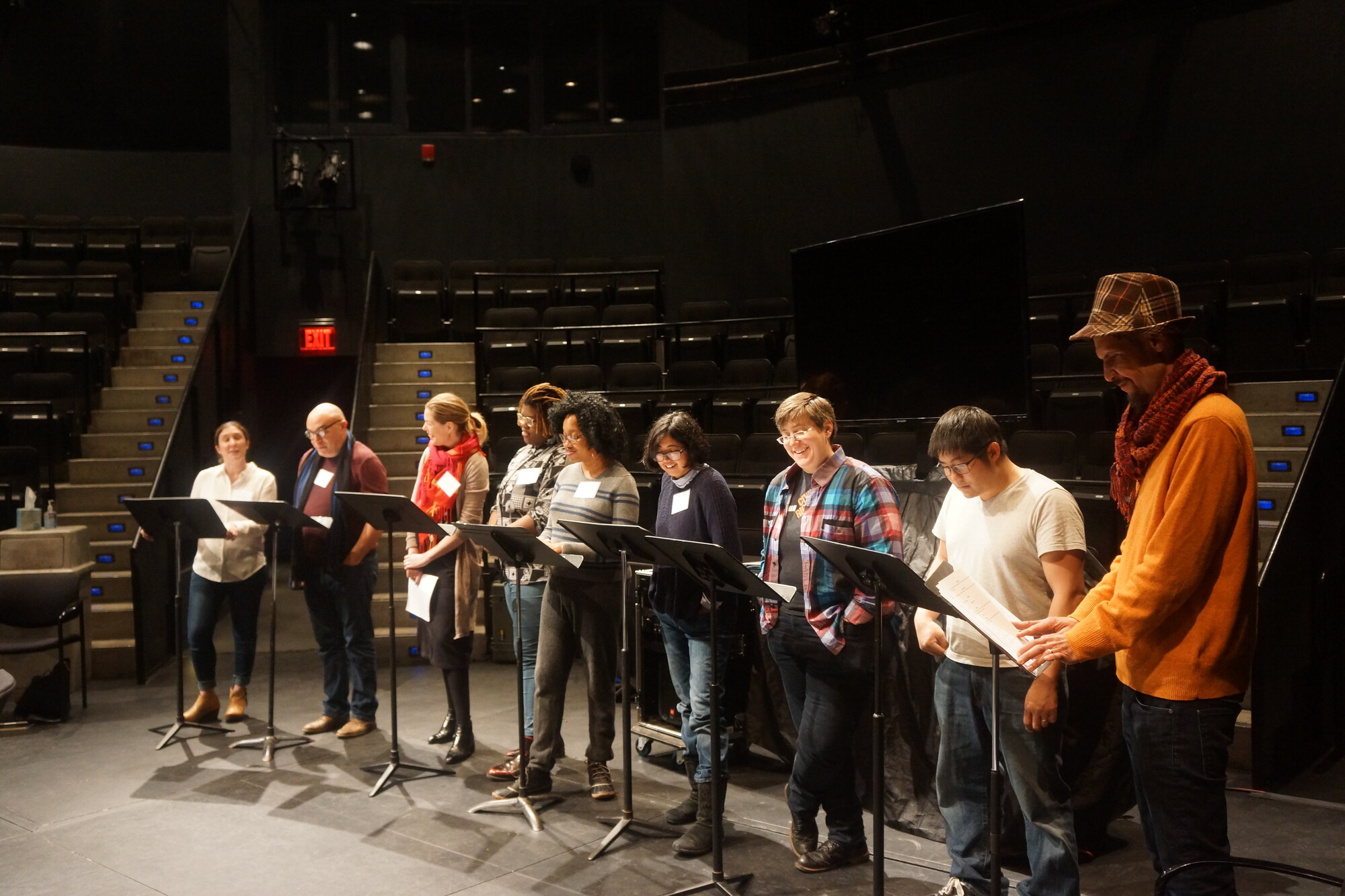 A group of people standing behind music stands.