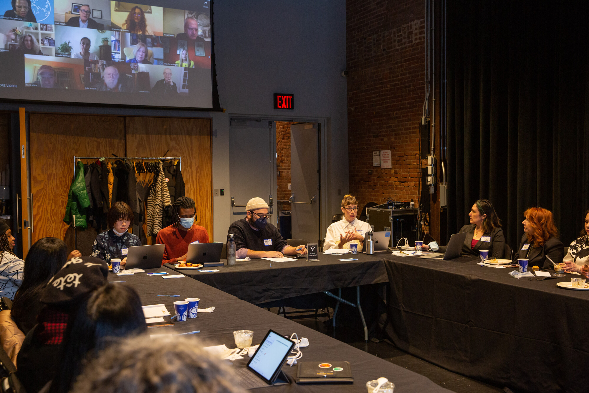 A group of people sitting around a large table.