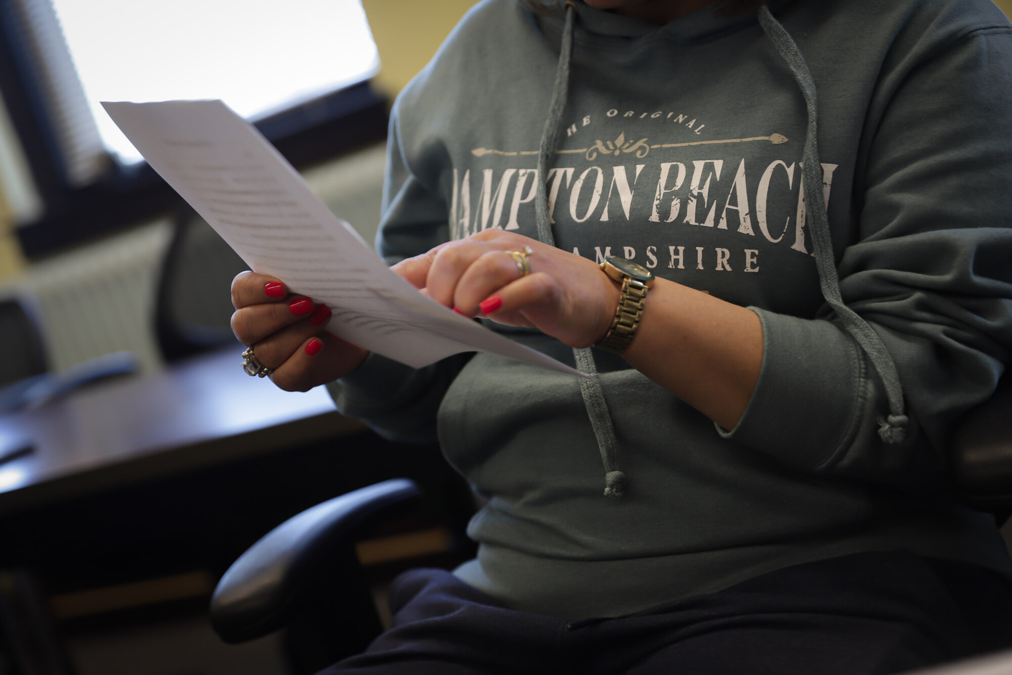 A person reading off a piece of paper.