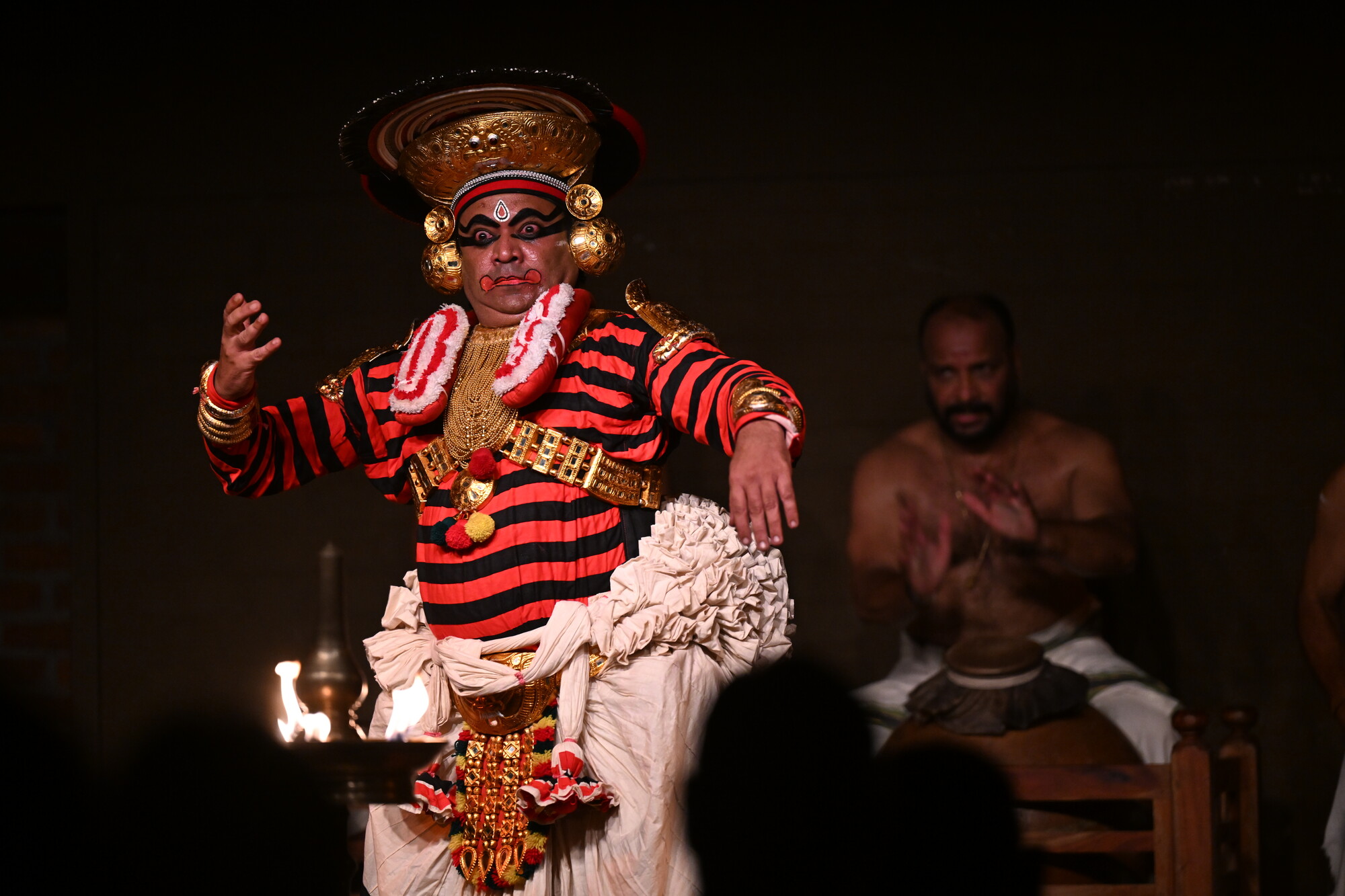 A man in traditional Indian clothing looking shocked.