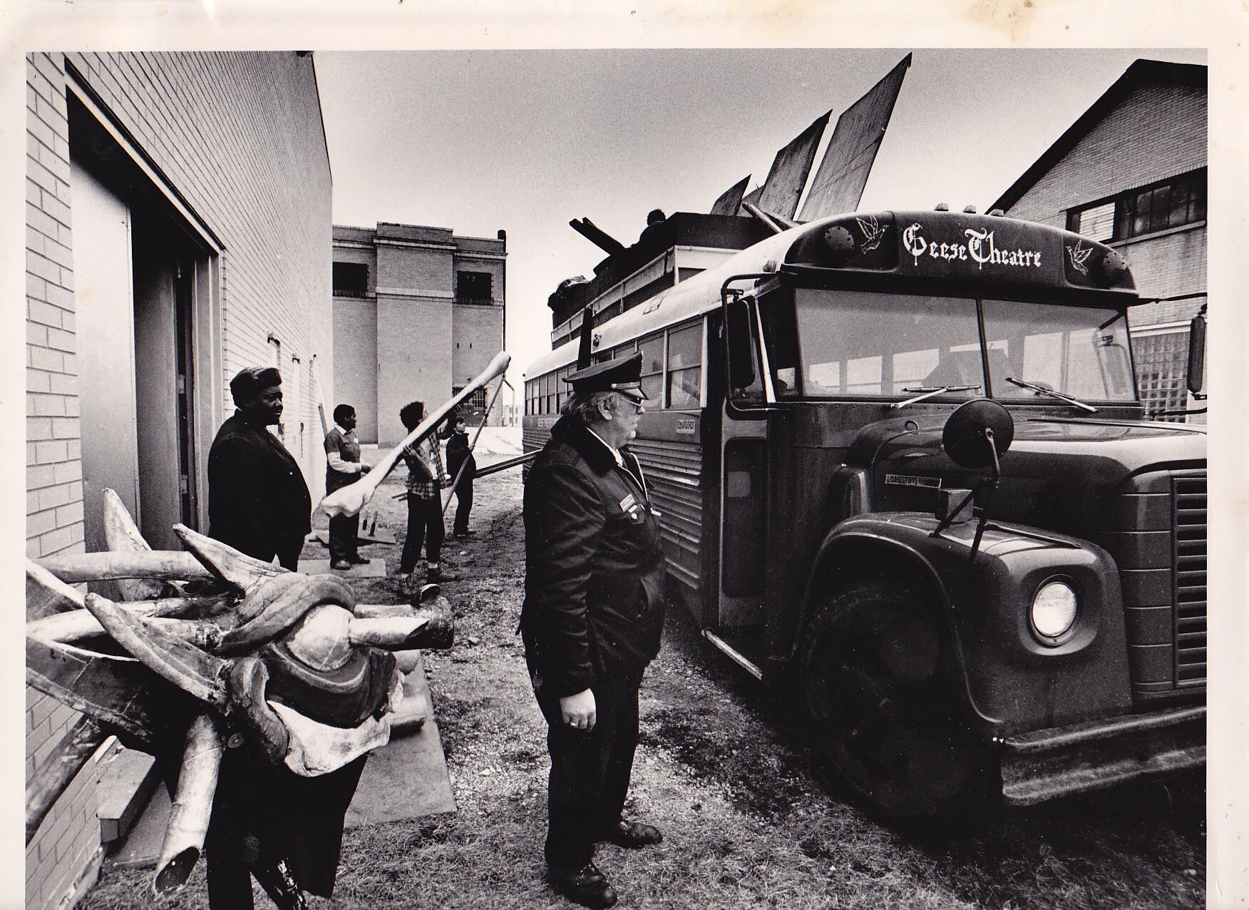A prison officer looking into a bus a black van.