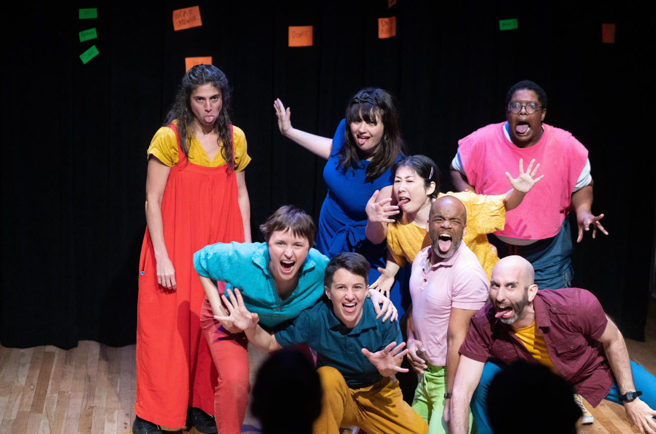 A group of people make silly faces onstage.