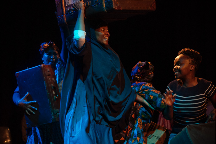 A group of people dance onstage.