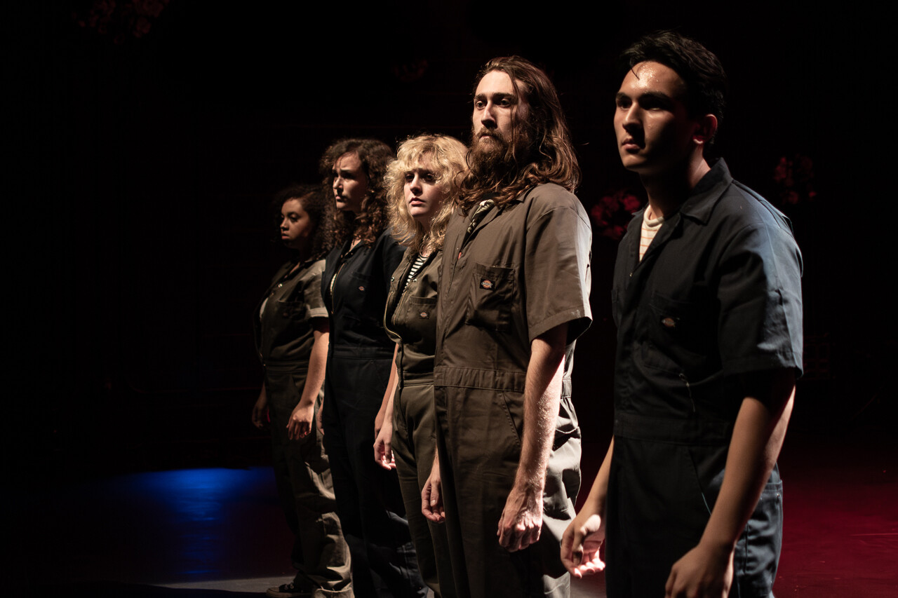 A group of actors stand in a line.
