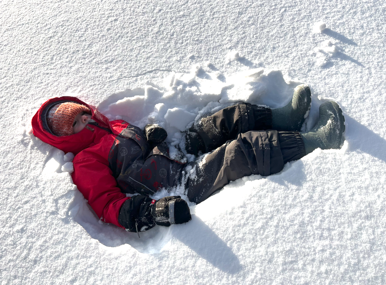 A child lies in the snow.