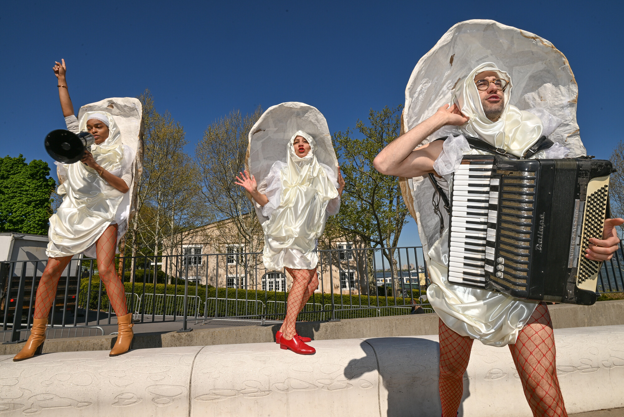 Three outdoor performers dressed as oysters.