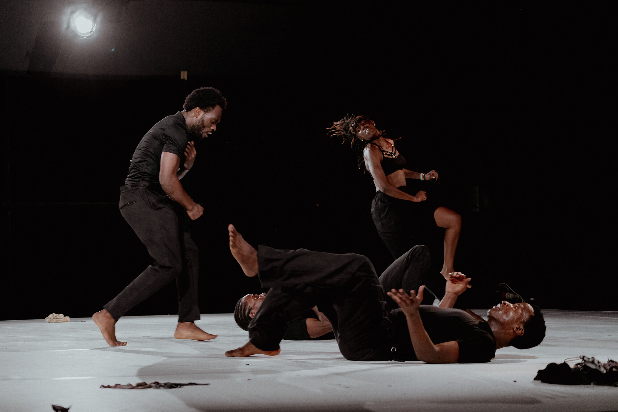 A group of dancers perform onstage.