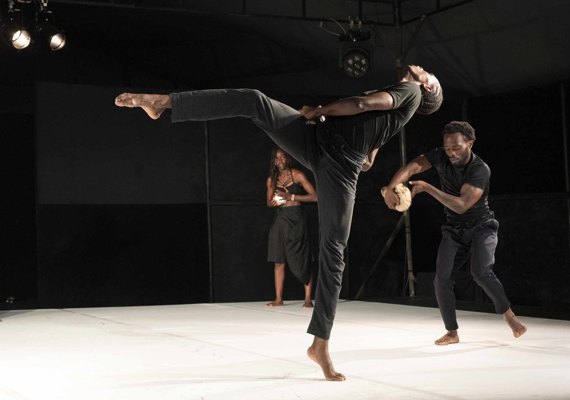 A group of dancers perform onstage.