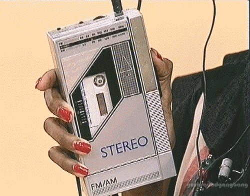 GIF of someone holding a portable cassette player.