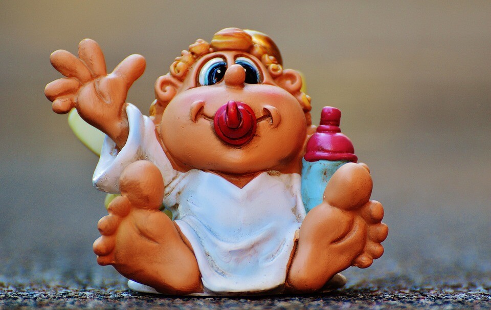 A cartoonish toy figure of a baby.