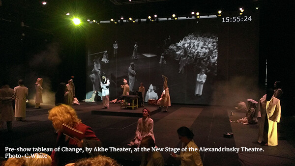 The company of Change scattered around the stage during a performance.