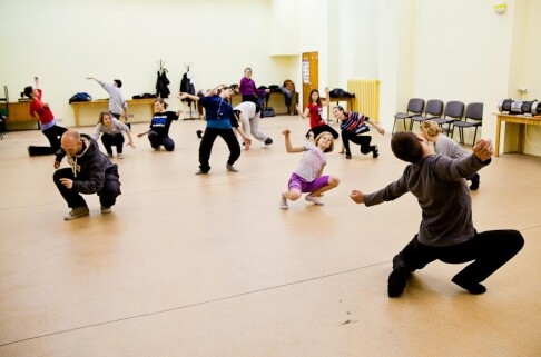 A group of dancers work during a rehearsal.