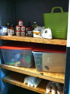 A pantry stocked with kitchen supplies.