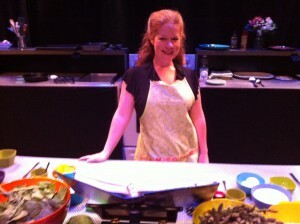 An actress in an apron onstage.